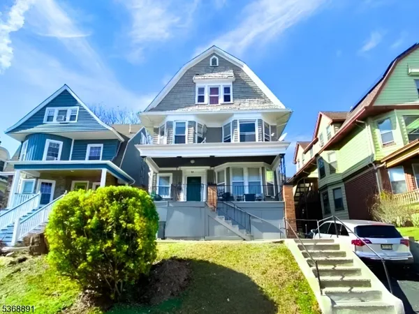a front view of a residential houses with yard