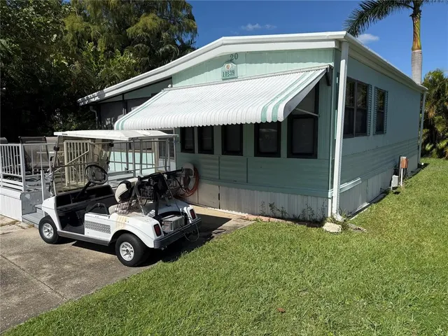 a view of a patio with table and chairs under an umbrella