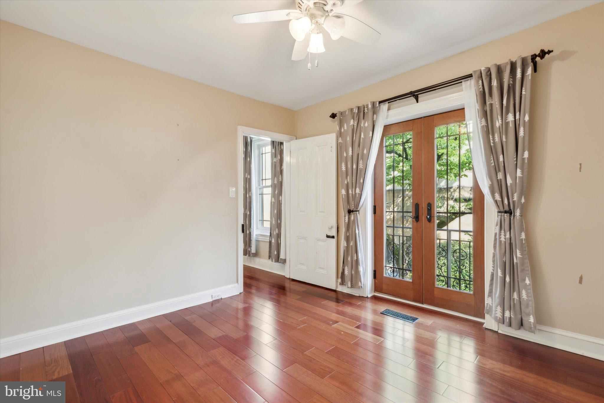 6113 Ridge Avenue Philadelphia, PA 19128 - Photo 11 of 25 a view of an empty room with wooden floor and a window