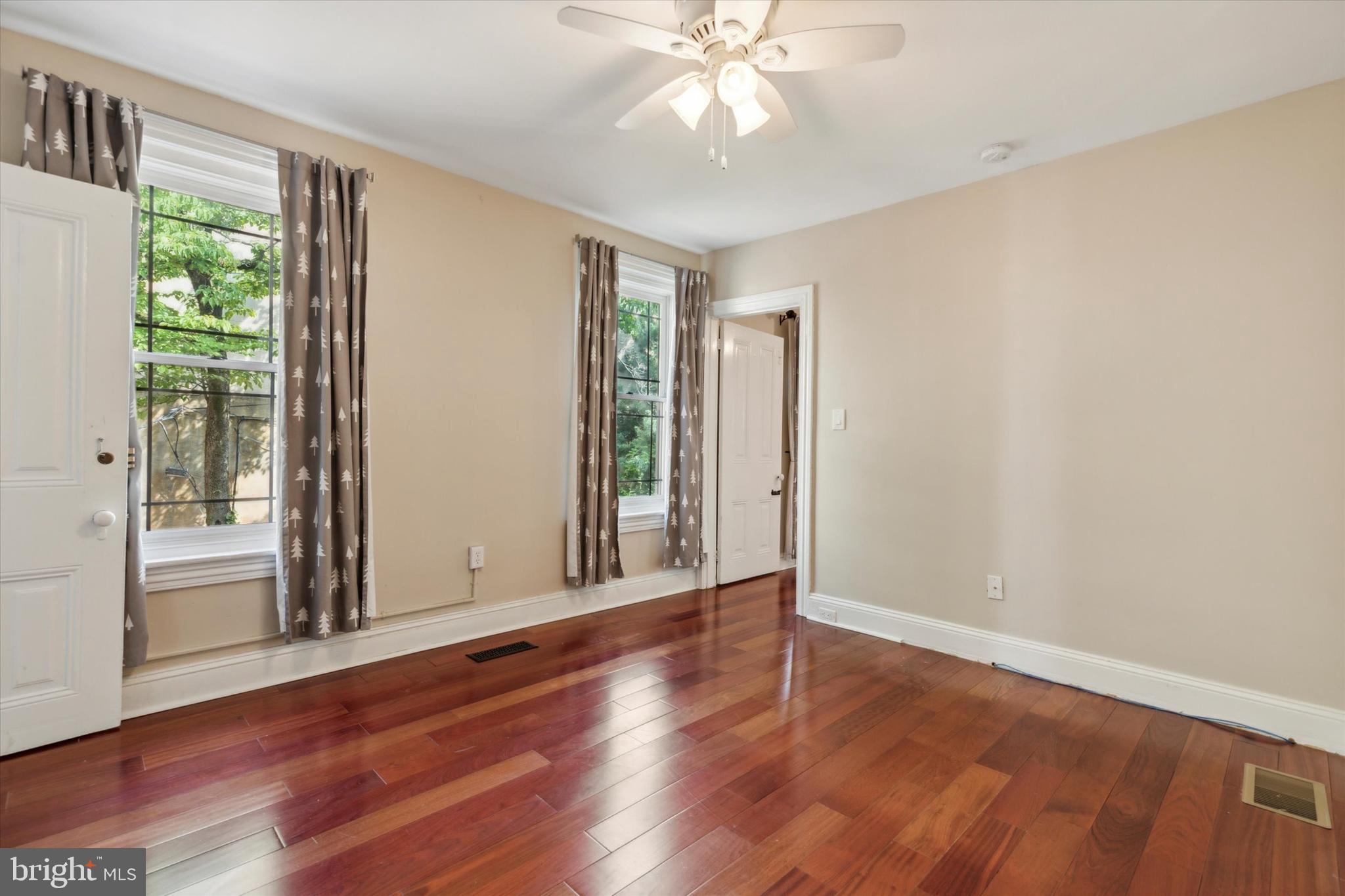 6113 Ridge Avenue Philadelphia, PA 19128 - Photo 9 of 25 a view of an empty room with wooden floor and a window