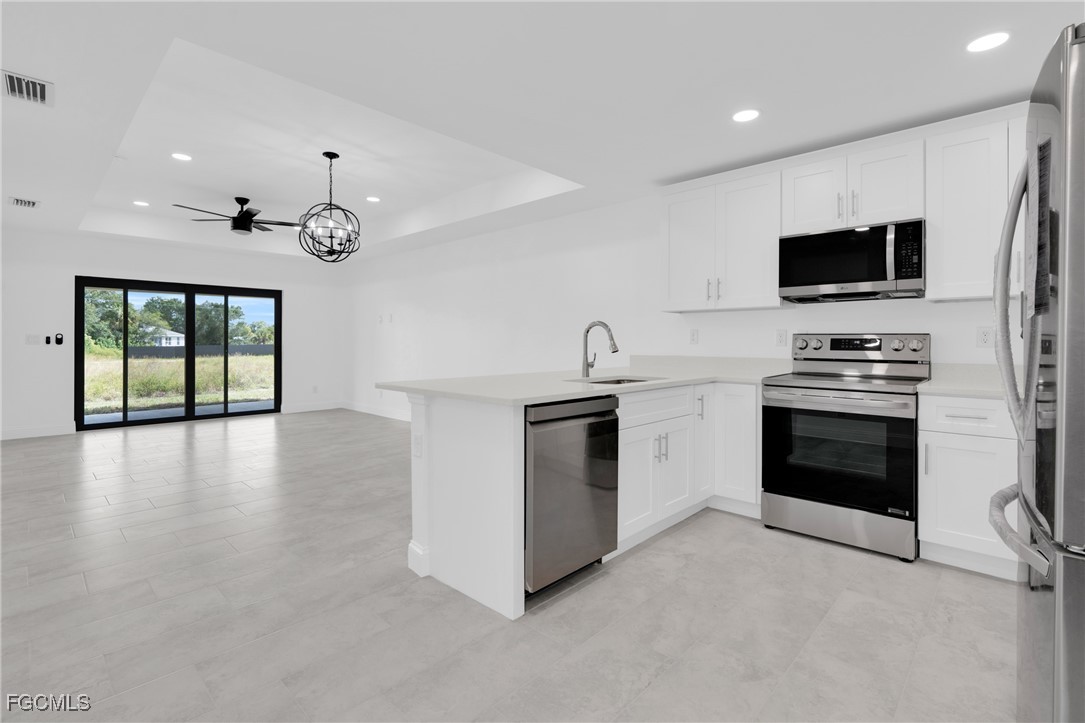 2508-2510 Park Road Lehigh Acres, FL 33971 - Photo 14 of 37 a kitchen with stainless steel appliances granite countertop a stove top oven a sink and a microwave