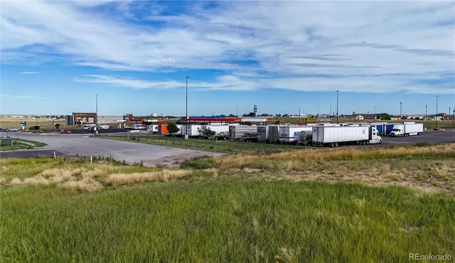 a view of swimming pool with lawn chairs