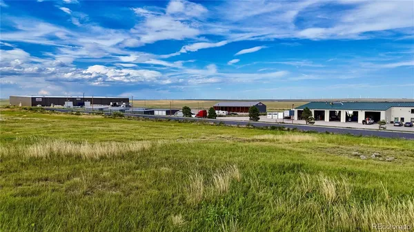 a view of a swimming pool with lawn chairs under an umbrella