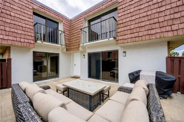 a backyard of a house with fire pit and couch