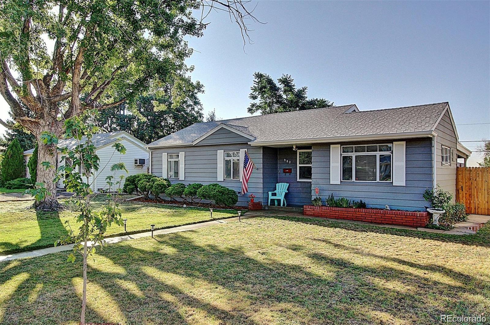 982 South Pecos Way Denver, CO 80223 - Photo 1 of 30 a front view of a house with a yard