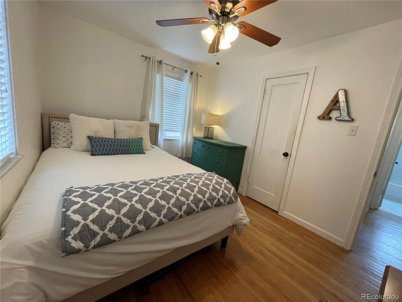 982 South Pecos Way Denver, CO 80223 - Photo 21 of 30 a bedroom with a bed and a mirror