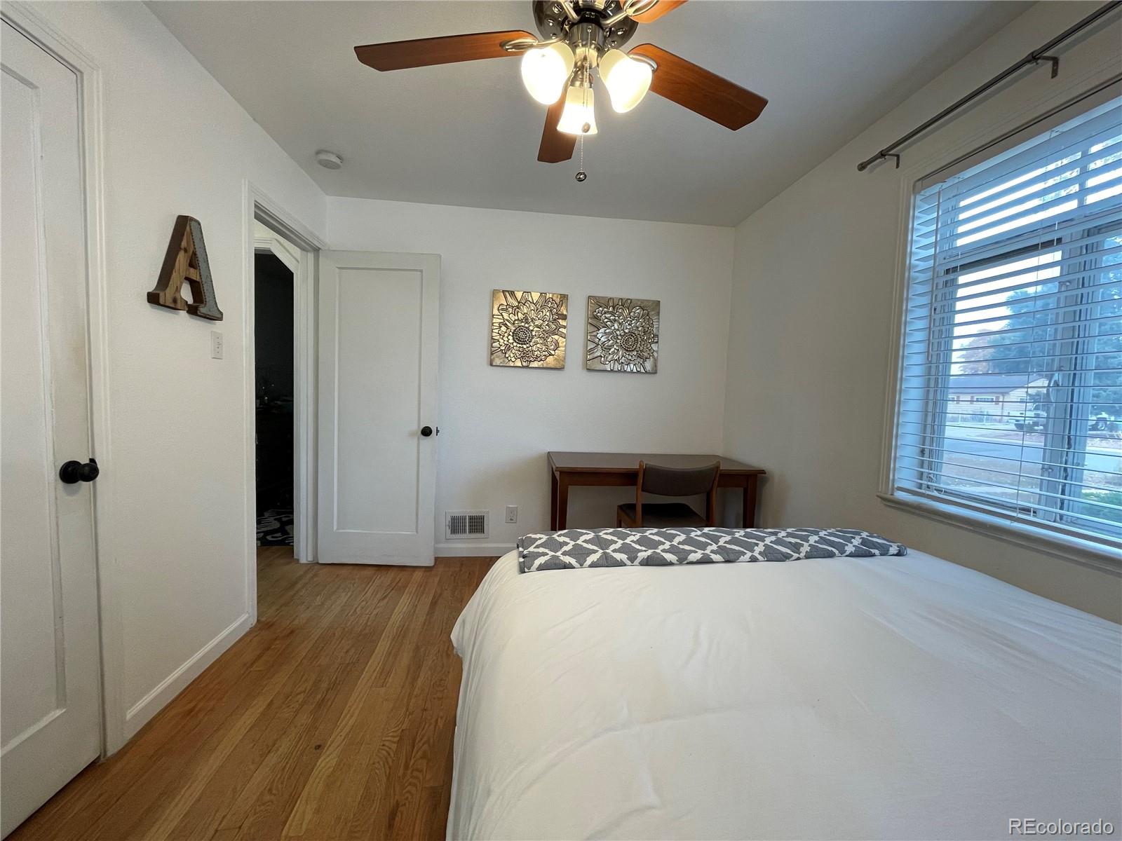 982 South Pecos Way Denver, CO 80223 - Photo 22 of 30 a bedroom with a large bed and a window