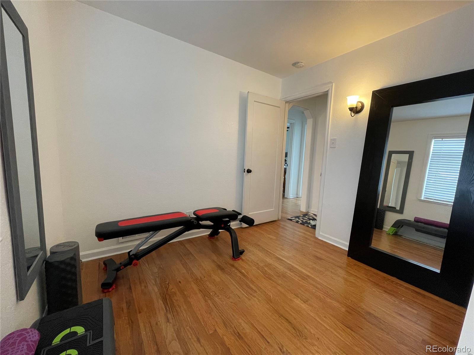 982 South Pecos Way Denver, CO 80223 - Photo 25 of 30 a view of a room with wooden floor and air conditioner