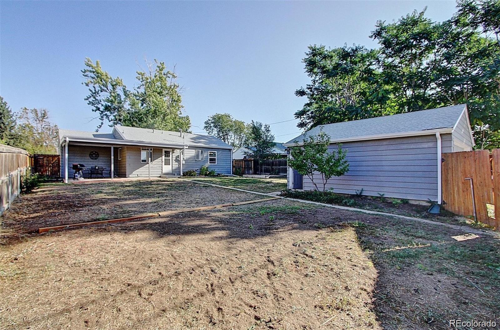 982 South Pecos Way Denver, CO 80223 - Photo 27 of 30 a view of a house with a yard