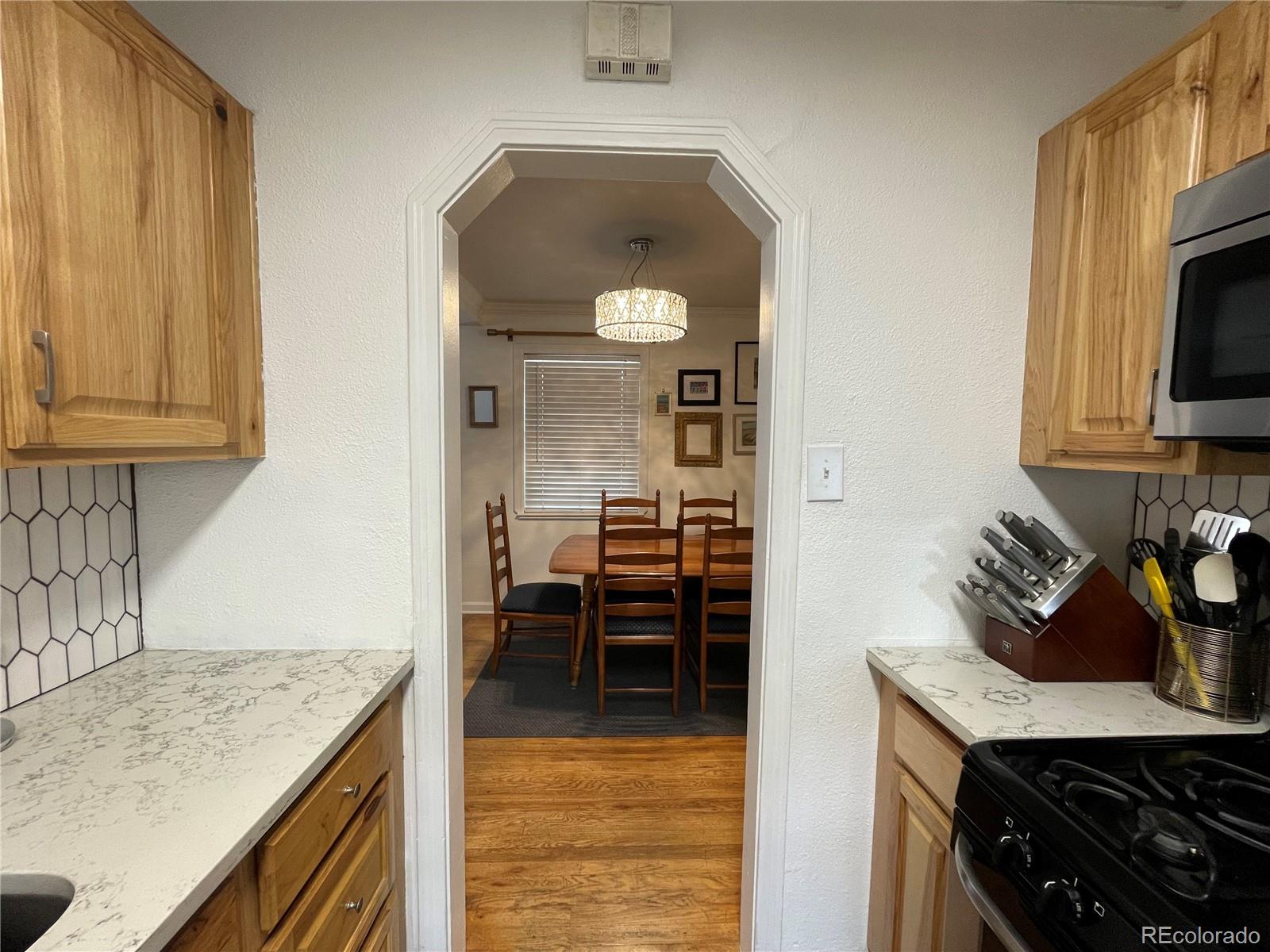 982 South Pecos Way Denver, CO 80223 - Photo 6 of 30 a kitchen with a stove and a sink