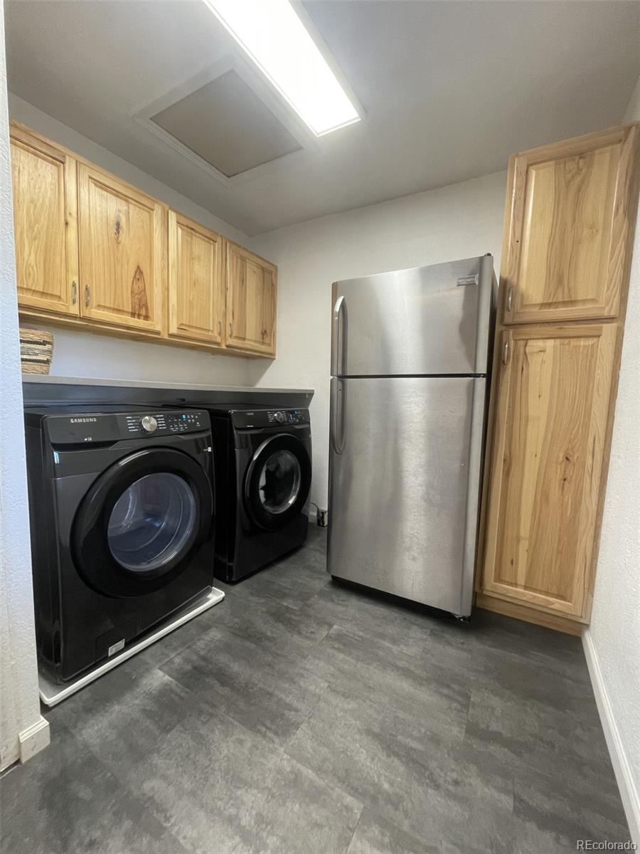 982 South Pecos Way Denver, CO 80223 - Photo 9 of 30 a view of a storage and utility room with washer and dryer