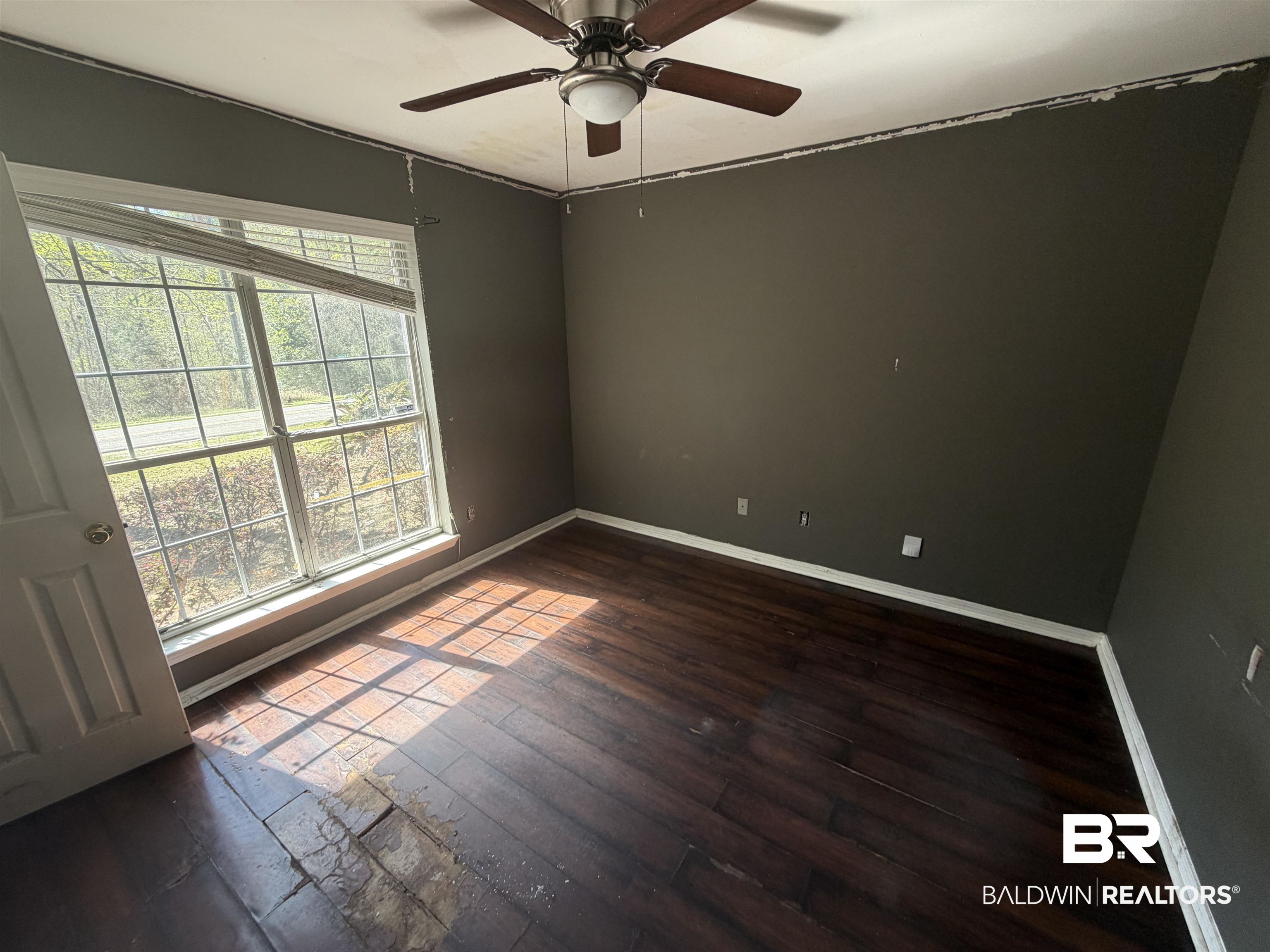 7067 Pinehill Road Daphne, AL 36526 - Photo 12 of 18 Unfurnished room with dark wood-type flooring and ceiling fan