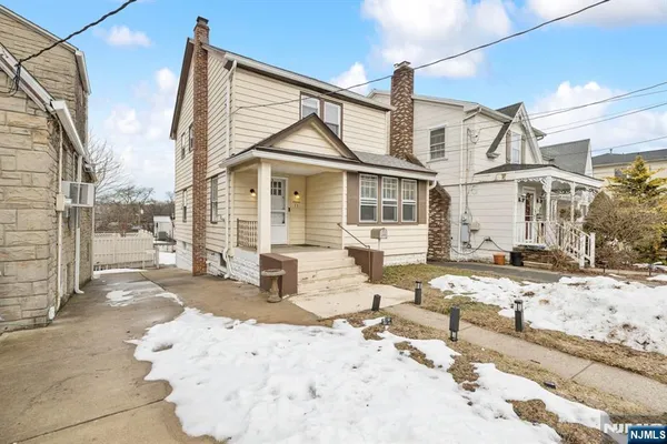 a view of a house with a snow on the road