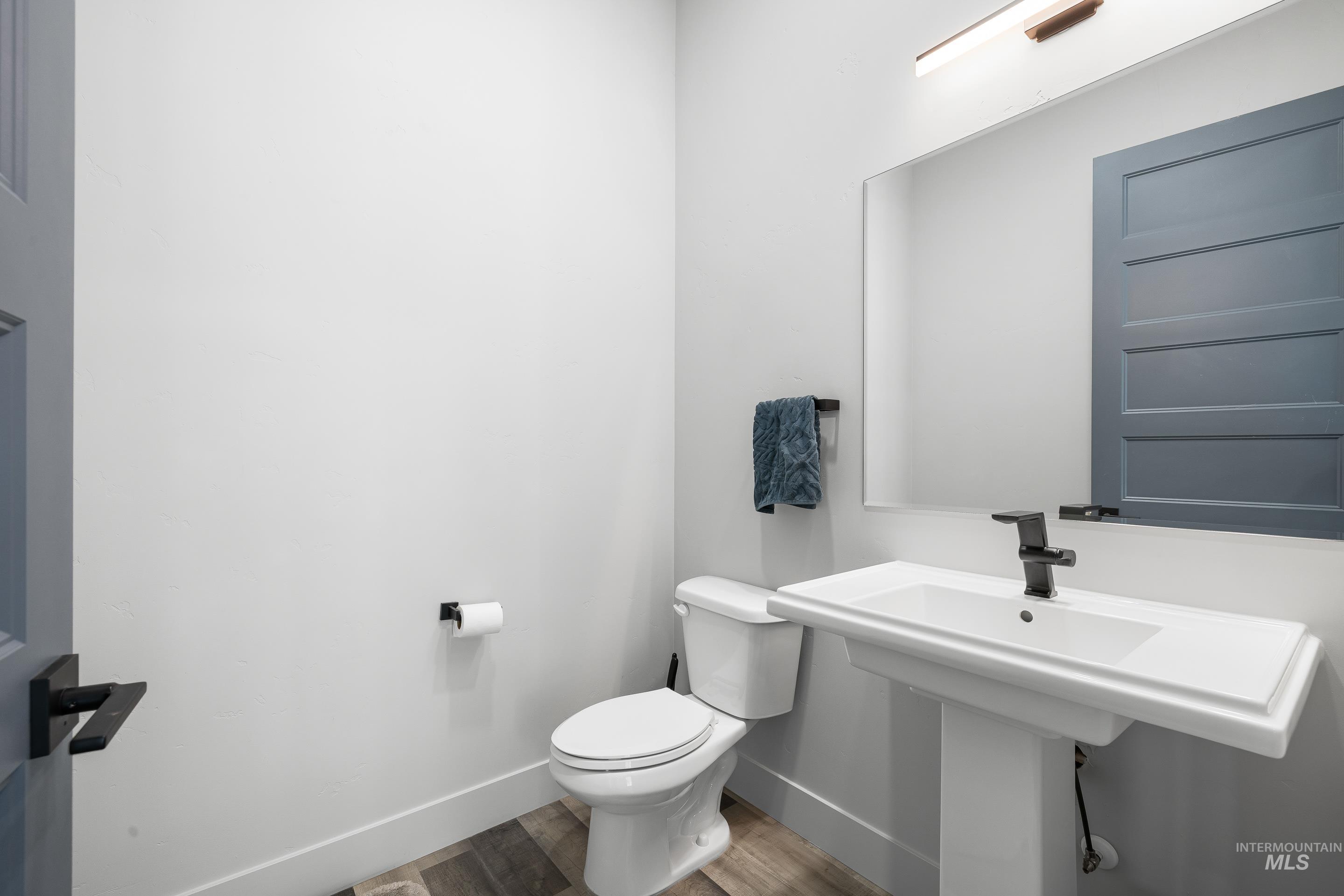 3483 South Grenze Way Meridian, ID 83642 - Photo 13 of 30 Half bathroom with toilet and wood finished floors