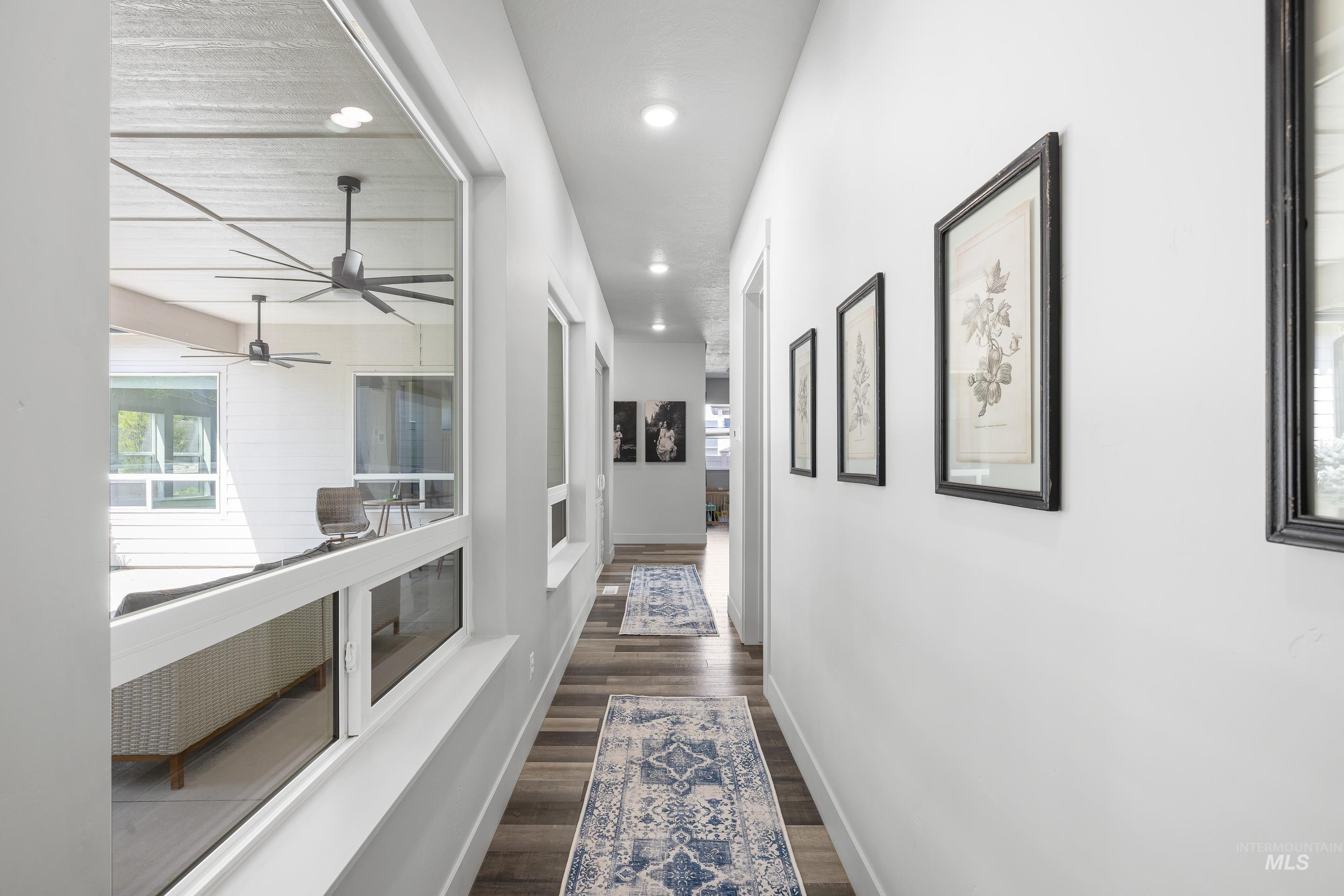 3483 South Grenze Way Meridian, ID 83642 - Photo 14 of 30 Hallway with healthy amount of natural light, recessed lighting, and dark wood-style floors