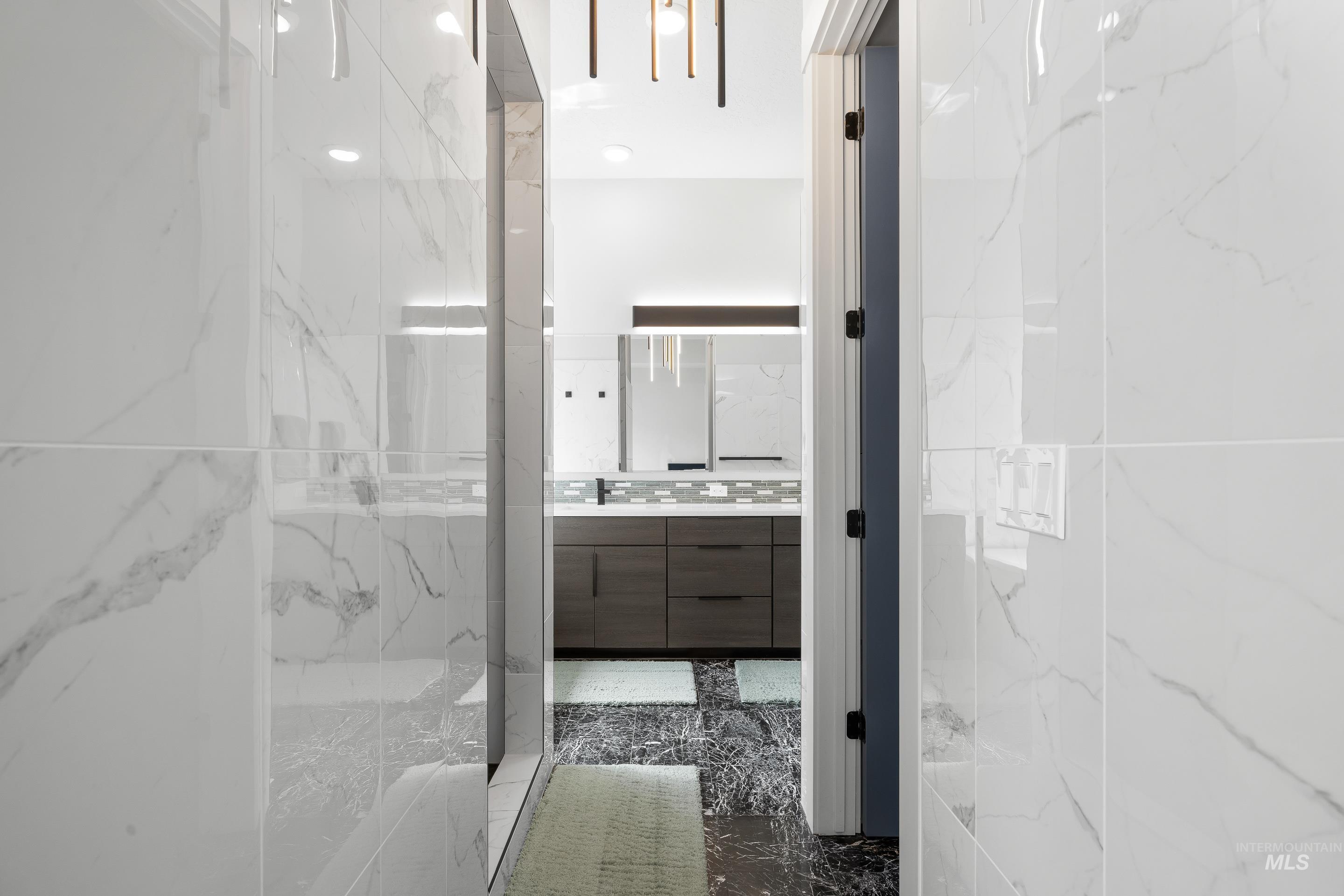 3483 South Grenze Way Meridian, ID 83642 - Photo 16 of 30 Bathroom with vanity, a marble finish shower, and dark marble finish flooring