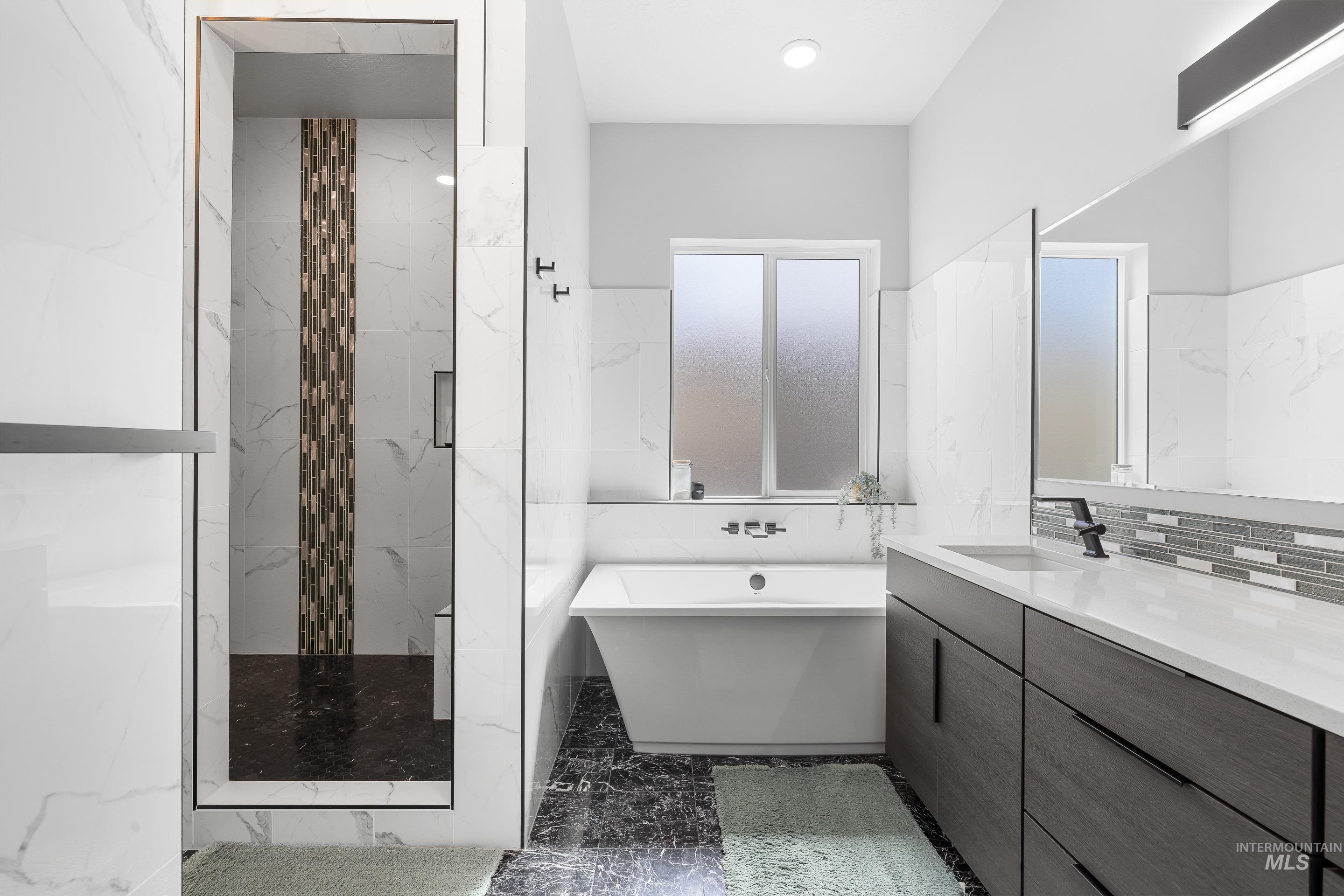 3483 South Grenze Way Meridian, ID 83642 - Photo 17 of 30 Full bathroom featuring vanity, a marble finish shower, a freestanding tub, dark marble finish floors, and recessed lighting