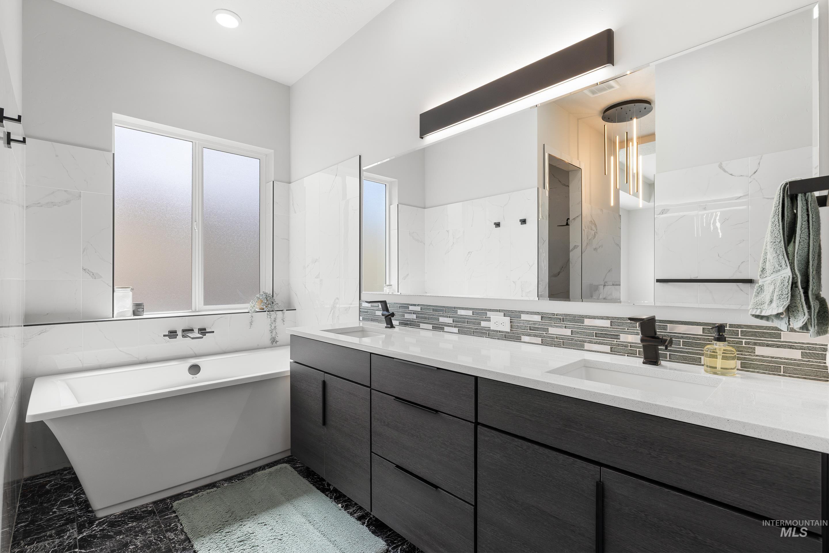 3483 South Grenze Way Meridian, ID 83642 - Photo 18 of 30 Full bathroom featuring double vanity, a freestanding tub, and light marble finish flooring