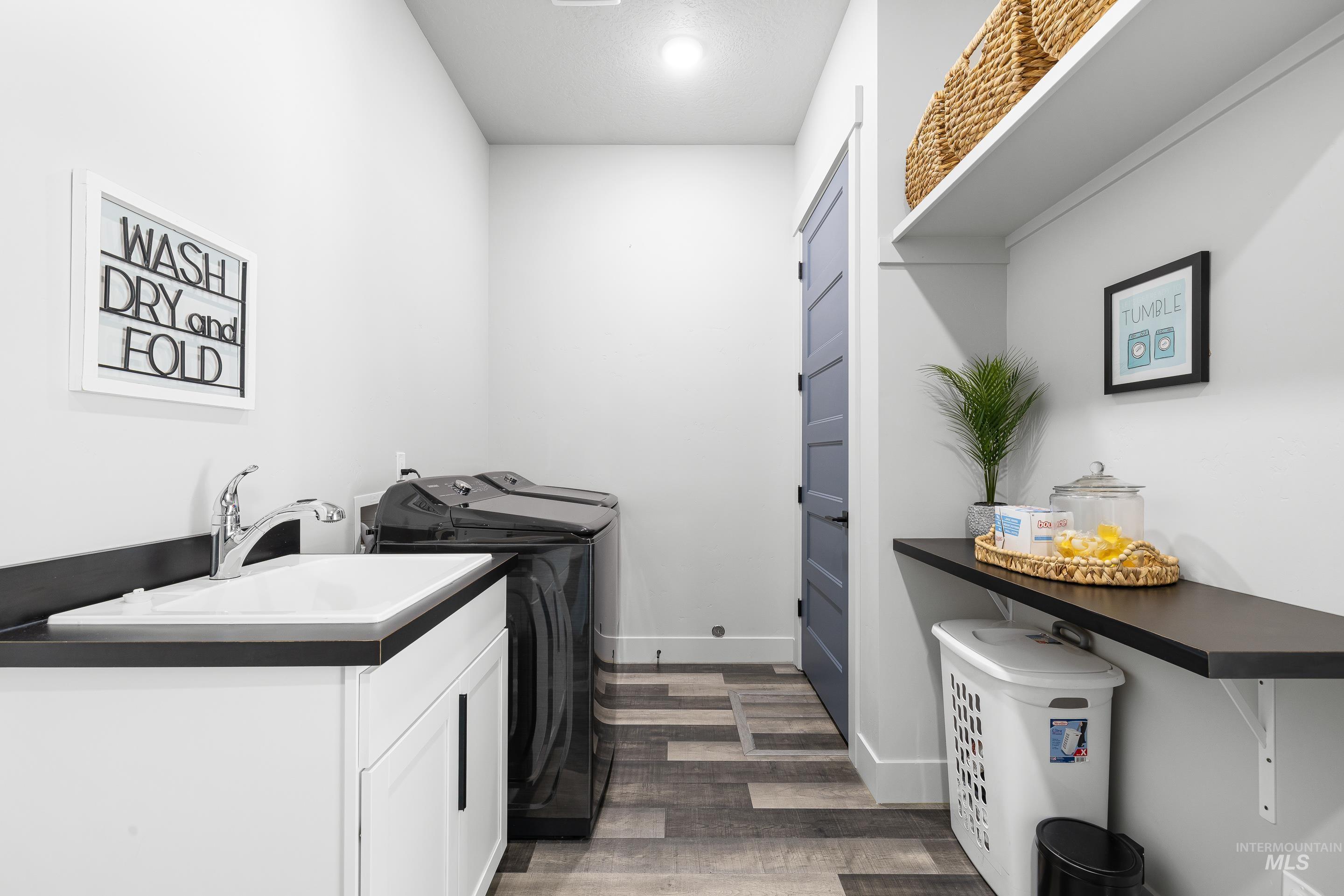 3483 South Grenze Way Meridian, ID 83642 - Photo 23 of 30 Laundry room featuring dark wood-style floors and washing machine and clothes dryer