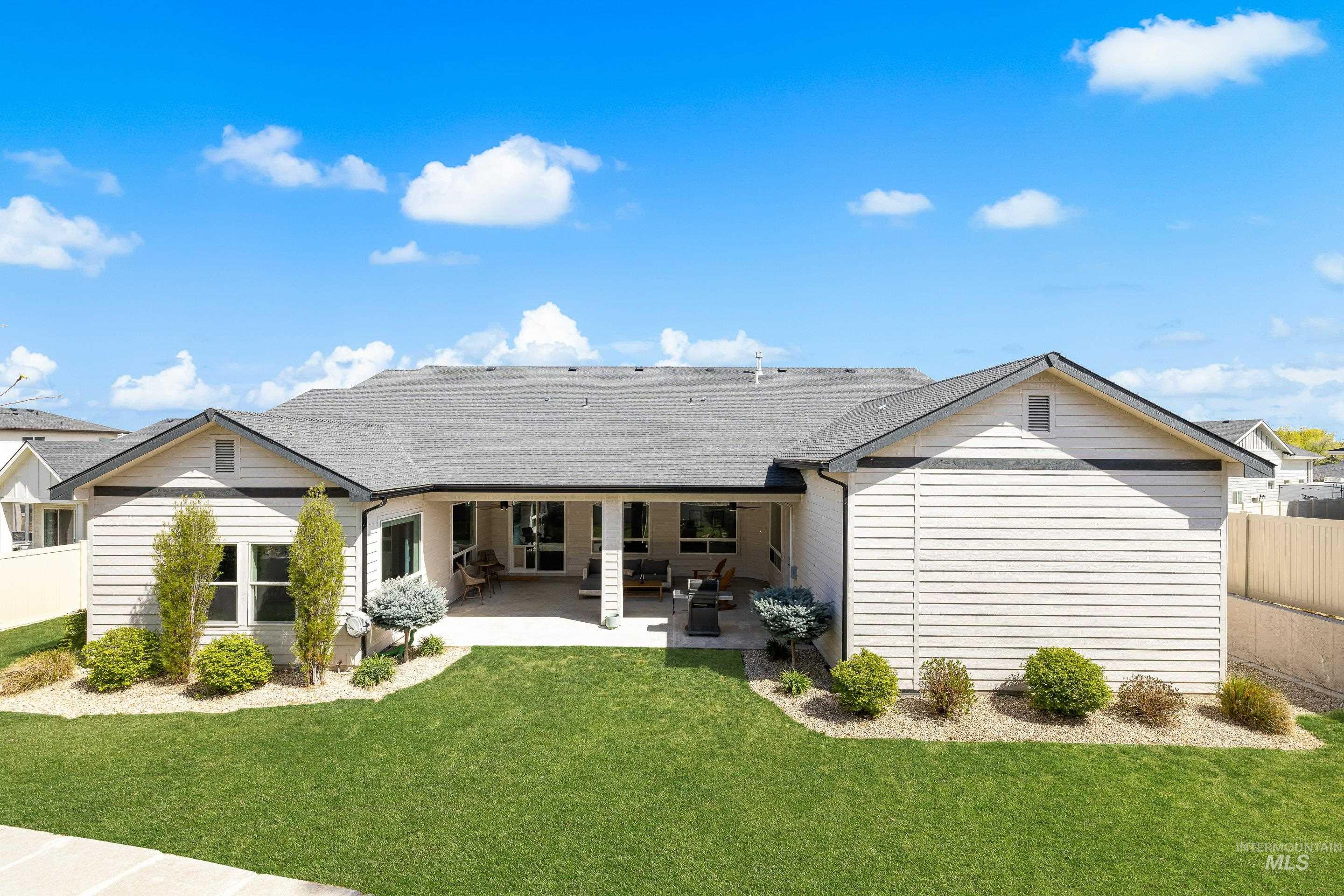 3483 South Grenze Way Meridian, ID 83642 - Photo 28 of 30 Back of house featuring roof with shingles and a patio