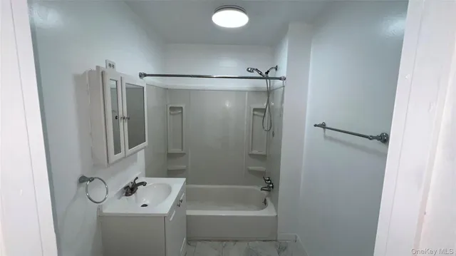 a bathroom with a tub and shower
