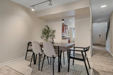 a view of a dining room with furniture and wooden floor