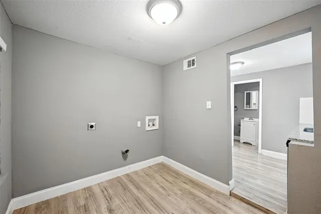 a view of a room with wooden floor