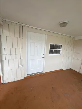 a view of an empty room with windows