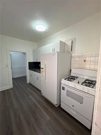 a kitchen with a stove and a refrigerator