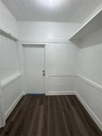 a view of a room with wooden floor