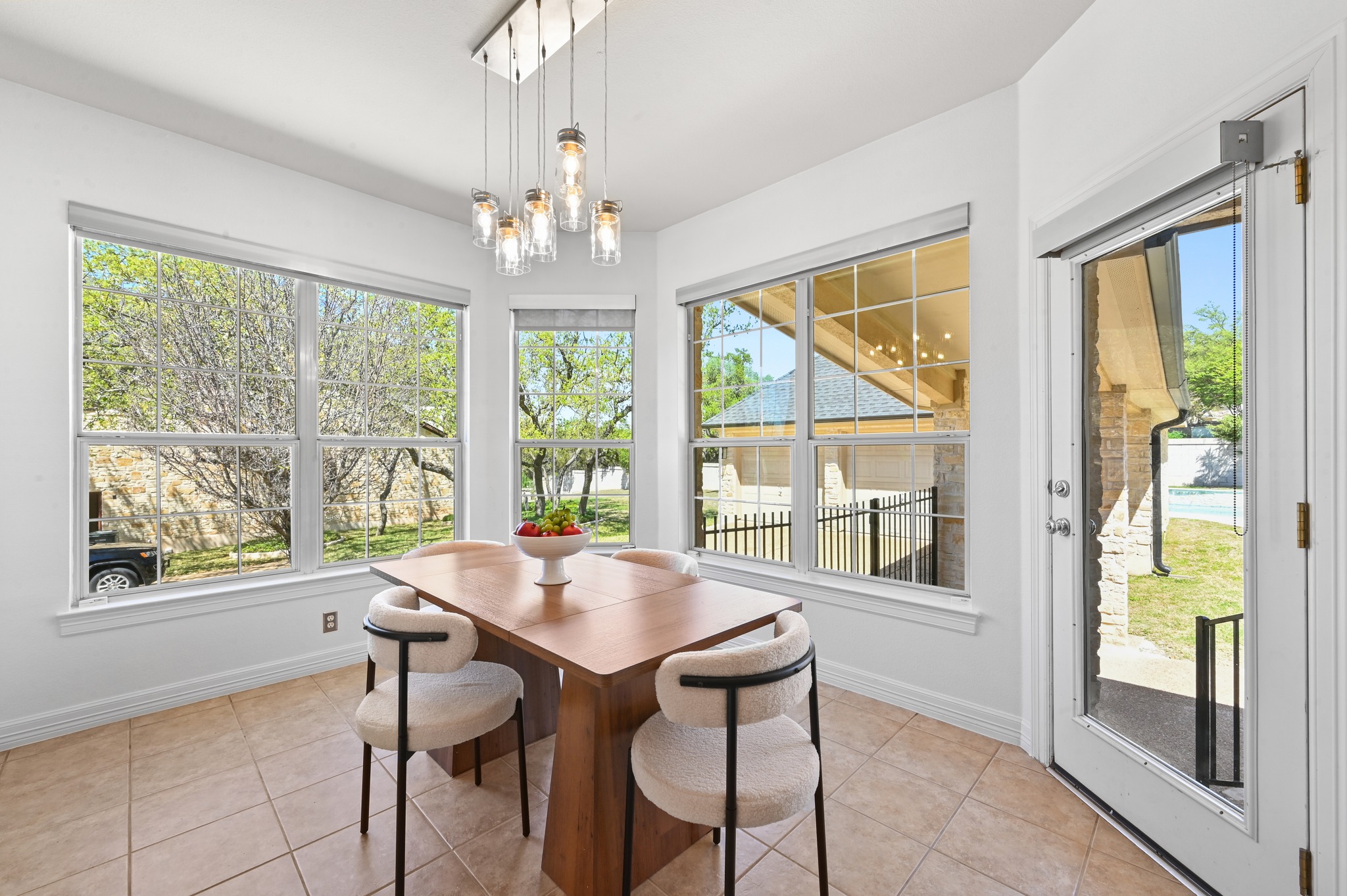 3125 Sun Drenched Path Austin, TX 78732 - Photo 15 of 38 Tucked between the kitchen and the windows, the breakfast area is a bright spot for morning coffee with a view of the backyard