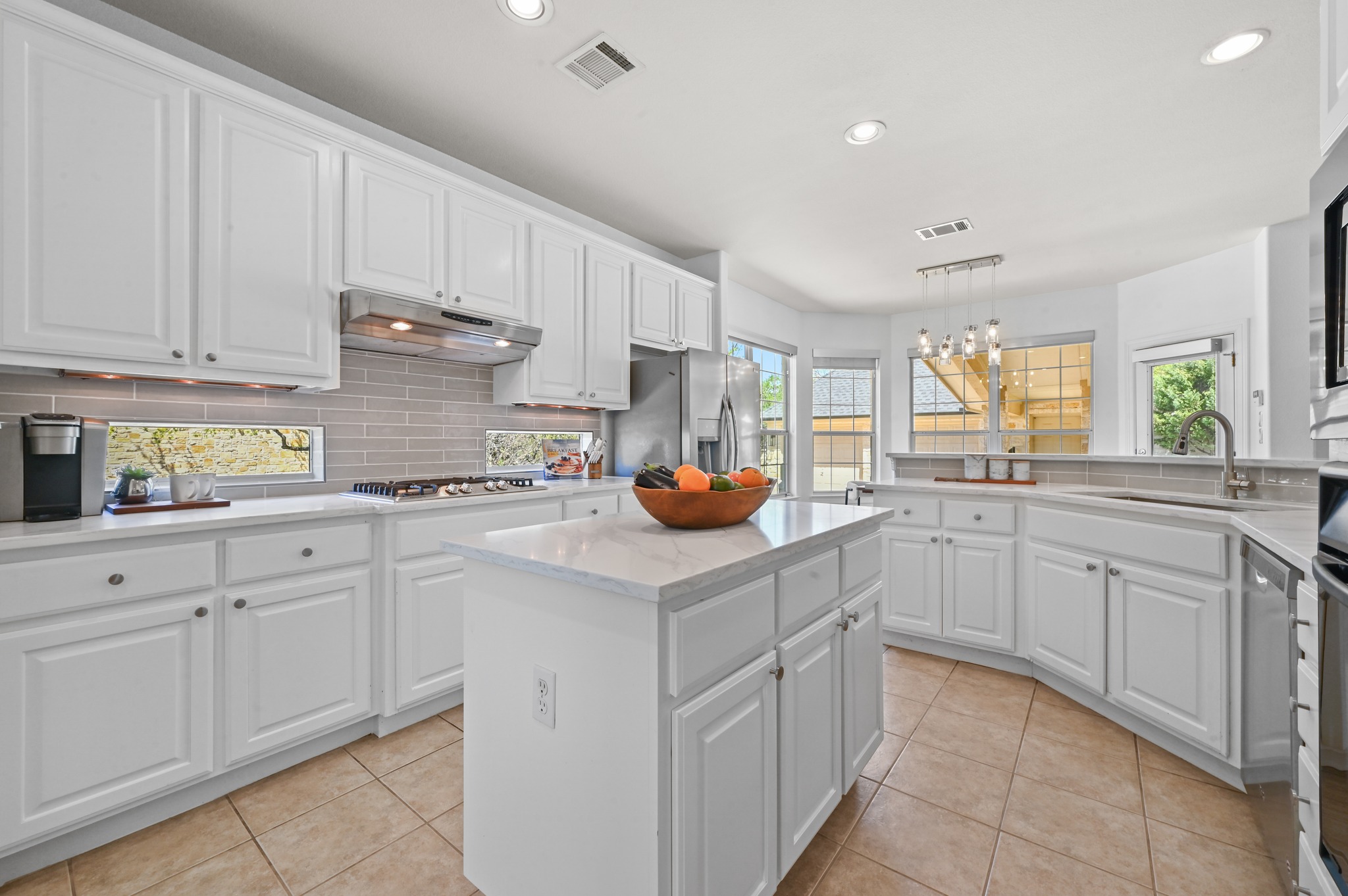 3125 Sun Drenched Path Austin, TX 78732 - Photo 17 of 38 The kitchen features a built-in oven and significant cabinet storage, providing a dedicated space for all your cooking essentials