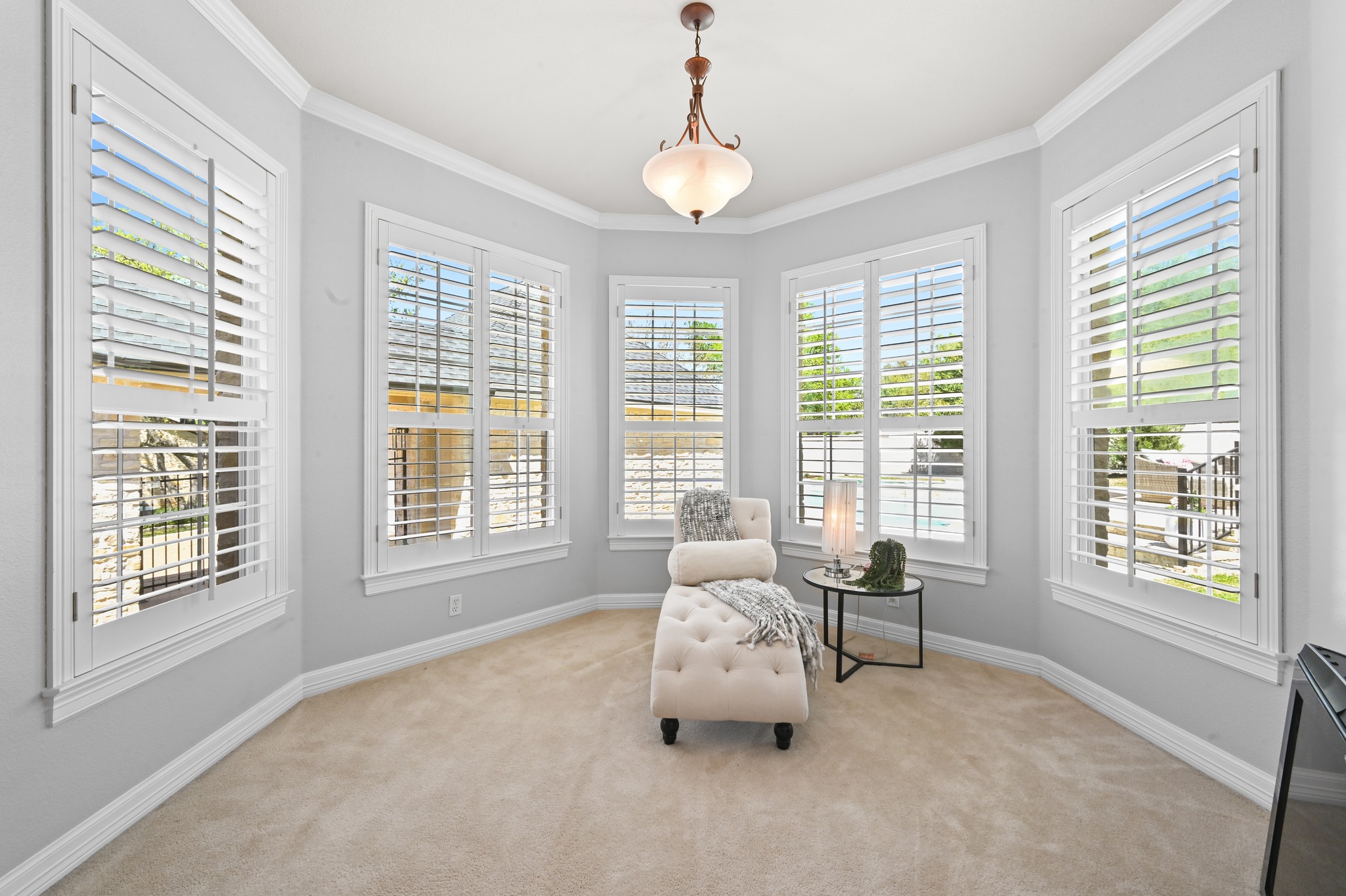 3125 Sun Drenched Path Austin, TX 78732 - Photo 19 of 38 Sunlight fills the primary bedroom through the wood-shuttered bay window, creating a bright and inviting retreat