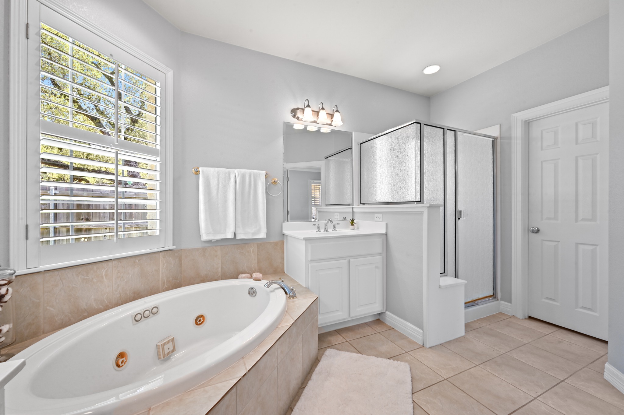 3125 Sun Drenched Path Austin, TX 78732 - Photo 20 of 38 With a dual vanity and a large walk-in closet, this primary bathroom has plenty of room for your morning routine