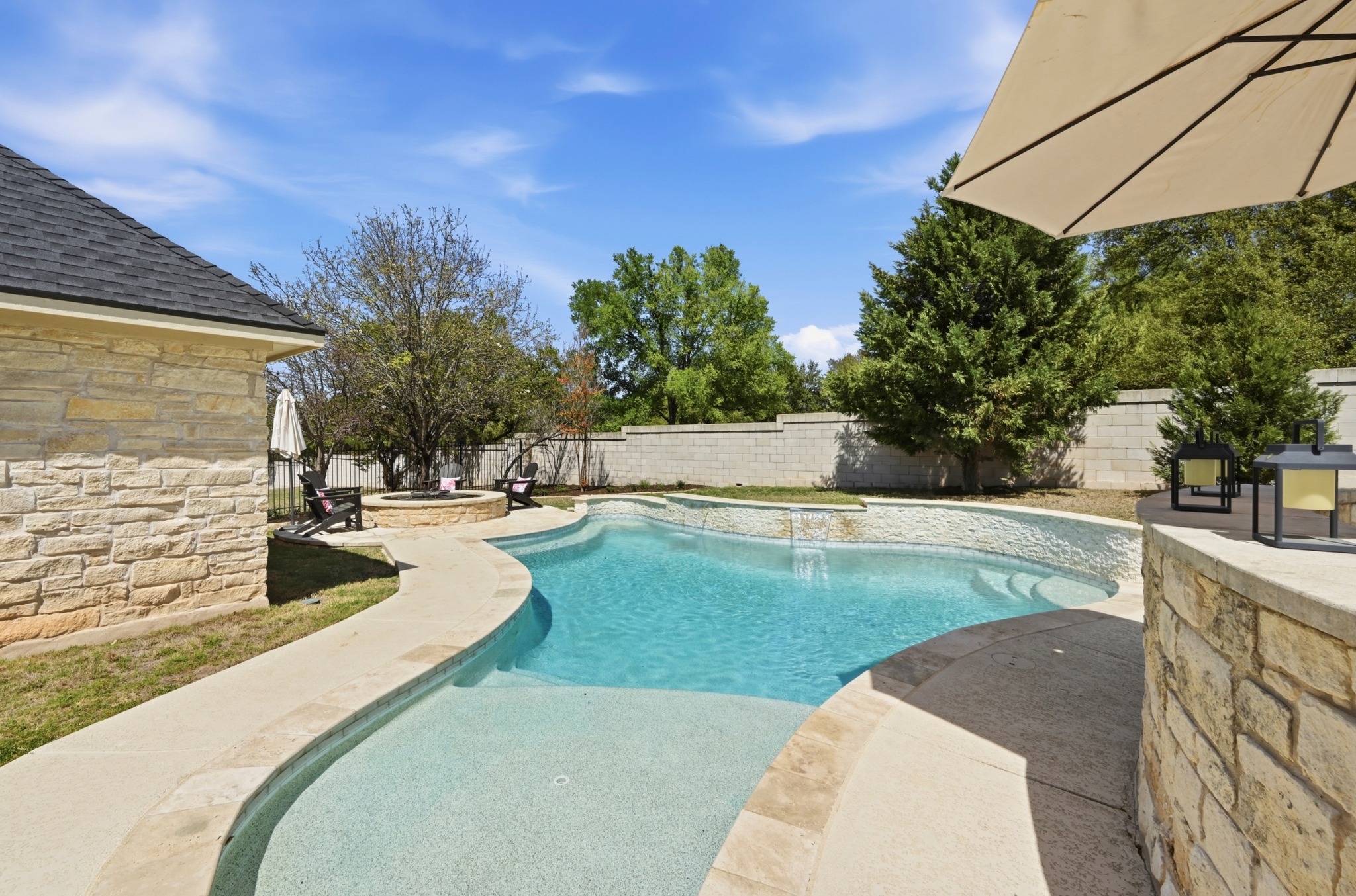 3125 Sun Drenched Path Austin, TX 78732 - Photo 29 of 38 The in-ground pool, added in 2021, features peaceful water sheers that create a resort-like atmosphere right in the backyard