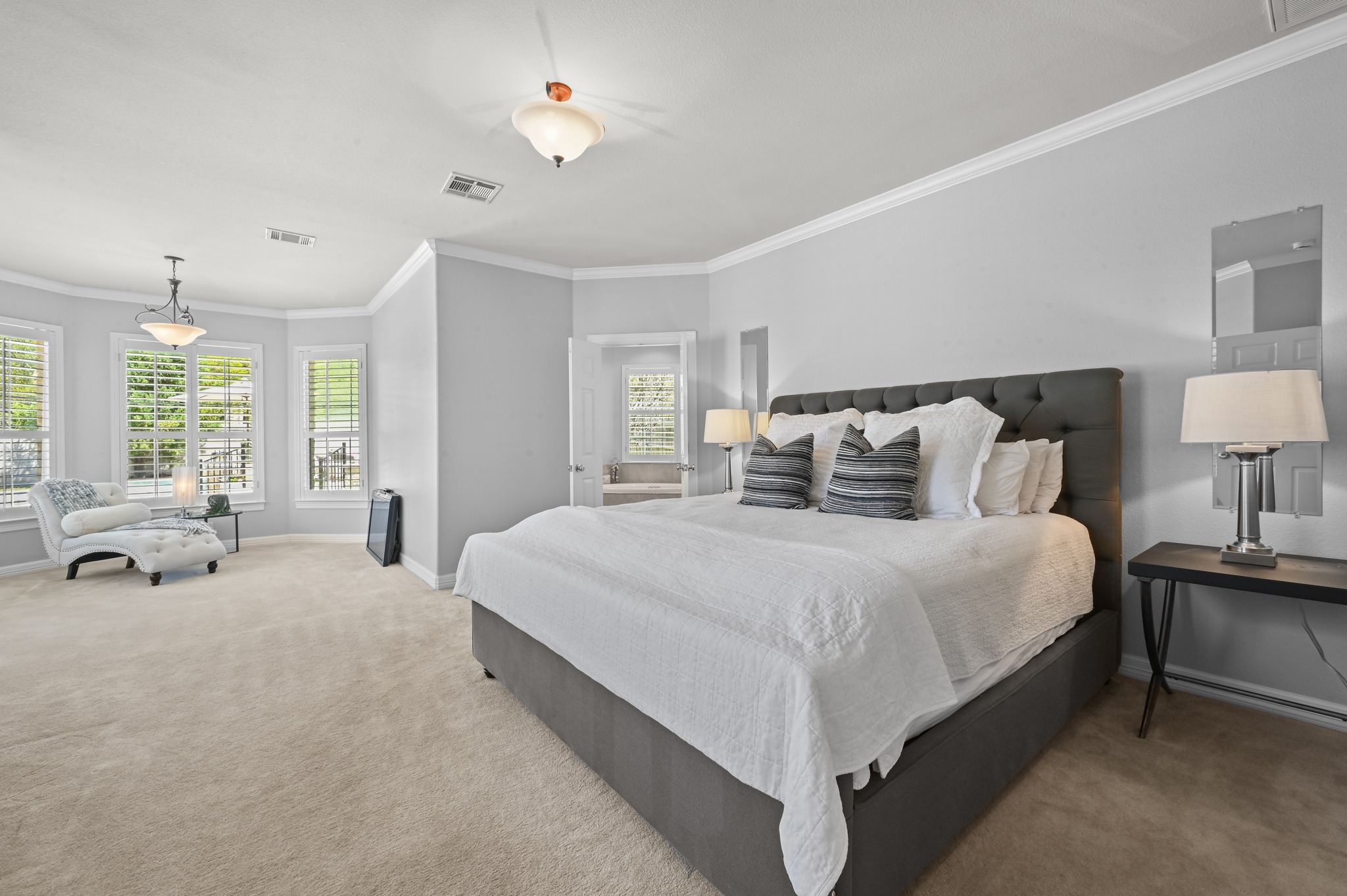 3125 Sun Drenched Path Austin, TX 78732 - Photo 4 of 38 This main-floor primary suite is quite spacious, with crown molding and a large bay window that makes for a perfect reading nook