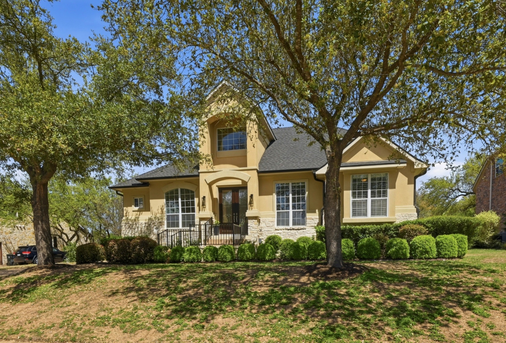 3125 Sun Drenched Path Austin, TX 78732 - Photo 7 of 38 The curb appeal welcomes you with a lush, landscaped lawn and mature trees that provide natural shade across the oversized lot