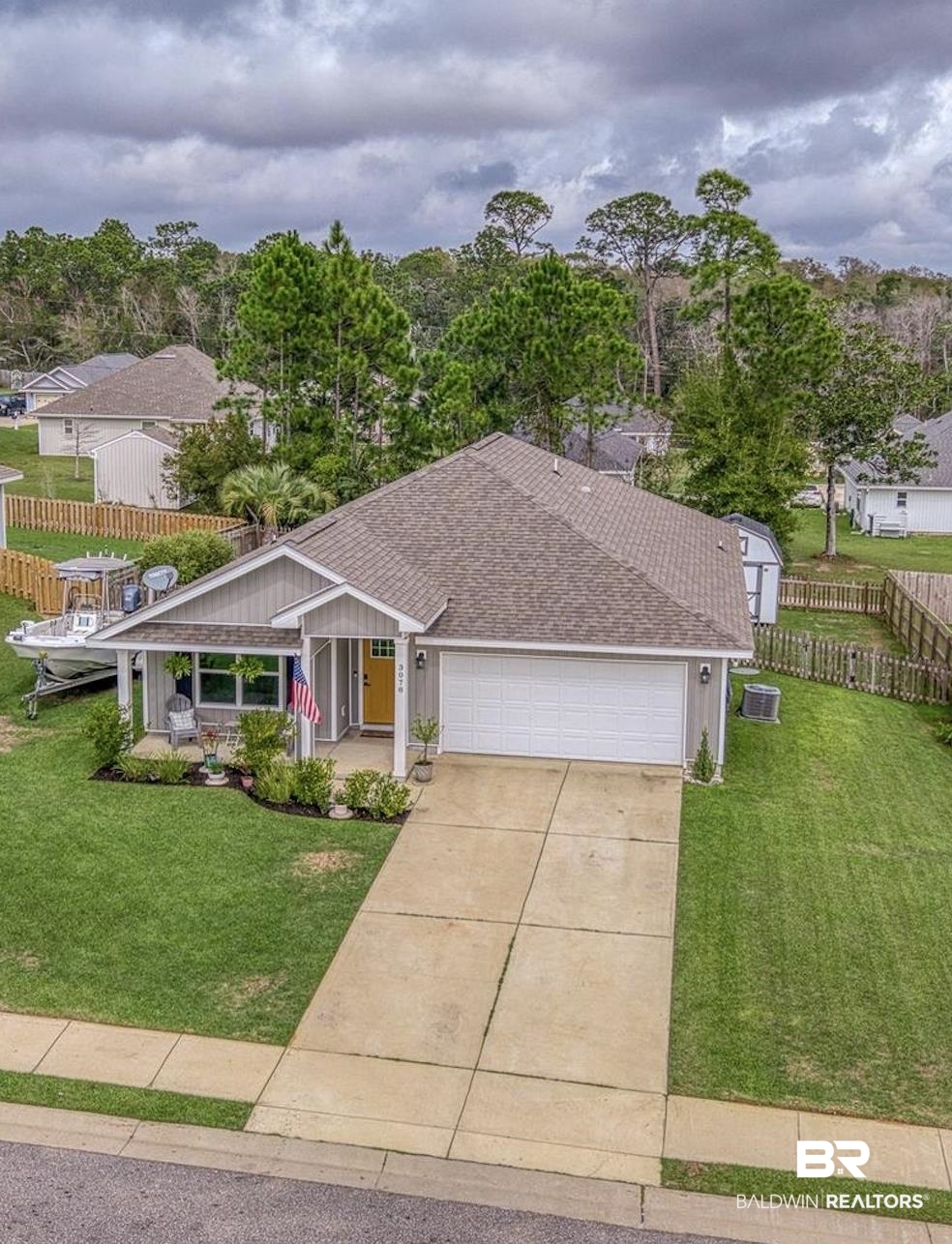 3078 Camino Real Loop Lillian, AL 36549 - Photo 29 of 51 View of front of property featuring covered porch, a shingled roof, a garage, driveway, and board and batten siding