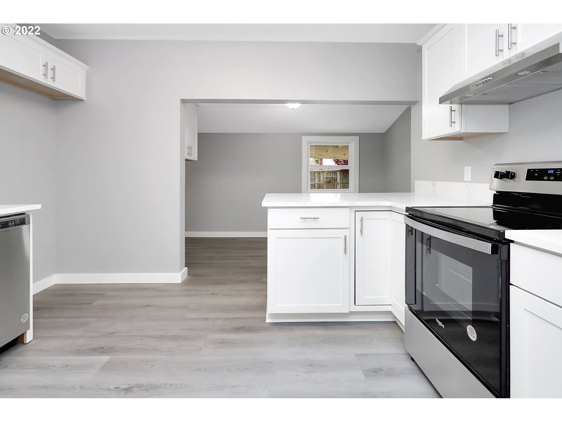 507 18th Avenue Longview, WA 98632 - Photo 5 of 29 a kitchen with a stove cabinets and wooden floor