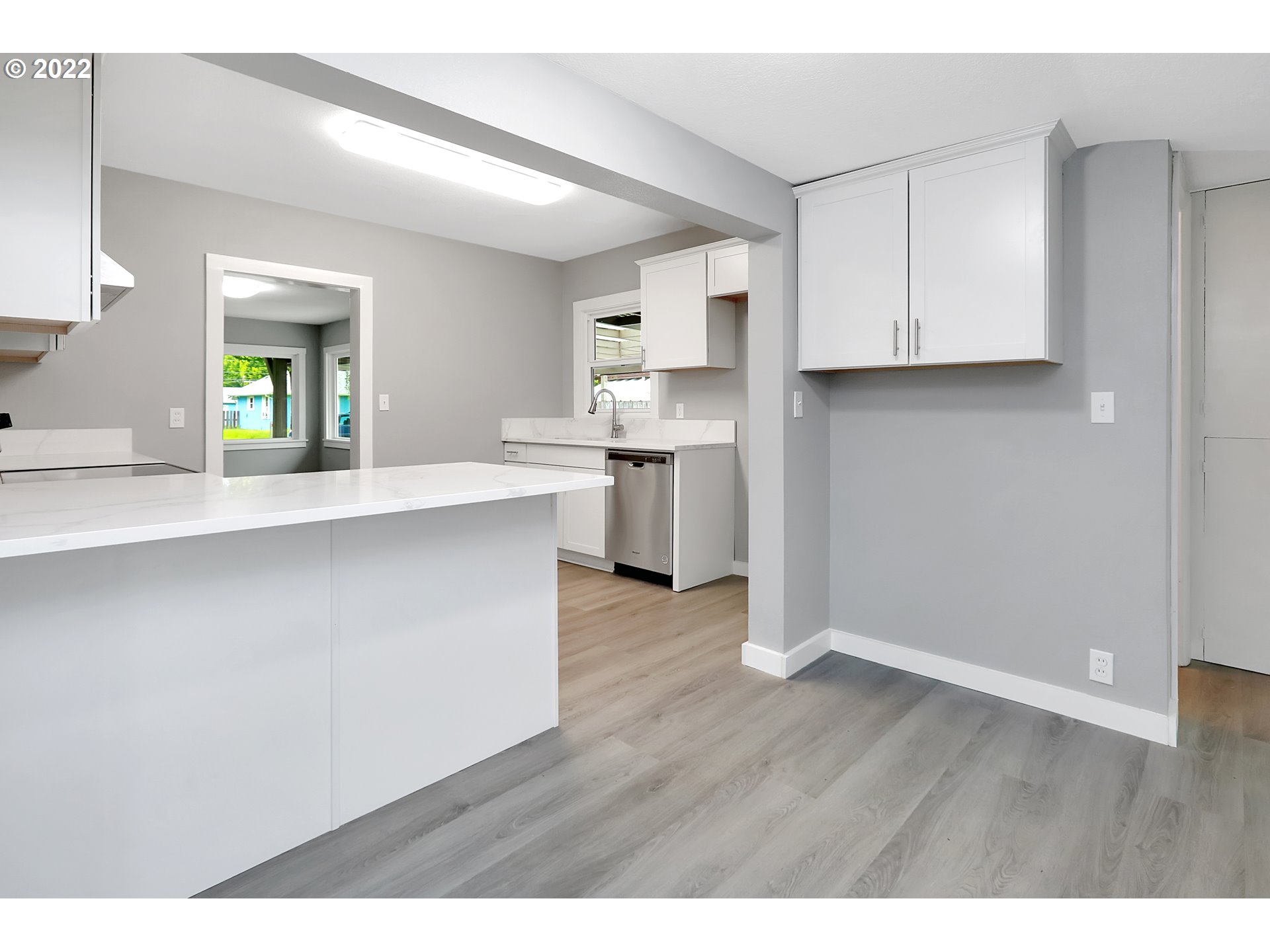 507 18th Avenue Longview, WA 98632 - Photo 6 of 29 a open kitchen with a white wooden cabinets and wooden floor