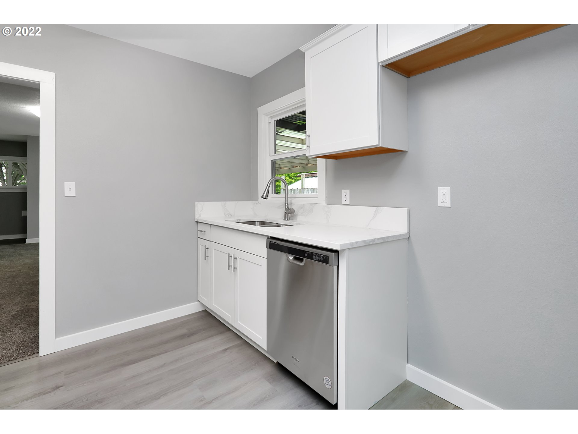 507 18th Avenue Longview, WA 98632 - Photo 7 of 29 a kitchen with a sink cabinets and a wooden floor