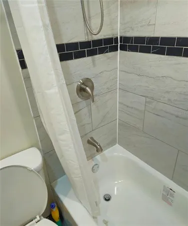 a bathroom with a granite countertop sink mirror vanity and toilet