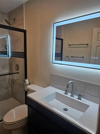 a bathroom with a toilet sink and shower