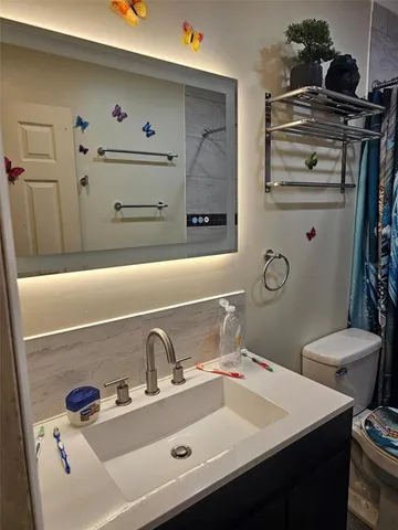 a bathroom with a shower and a toilet