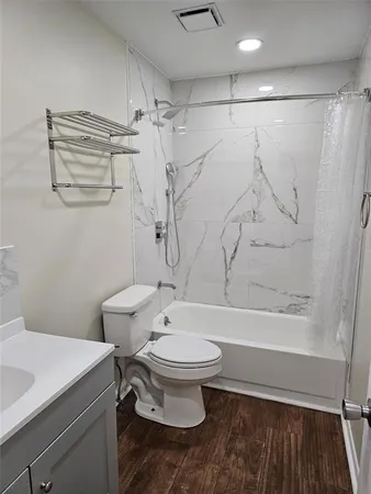 a view of an empty room and wooden floor