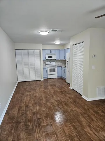a kitchen with a white cabinets and white appliances
