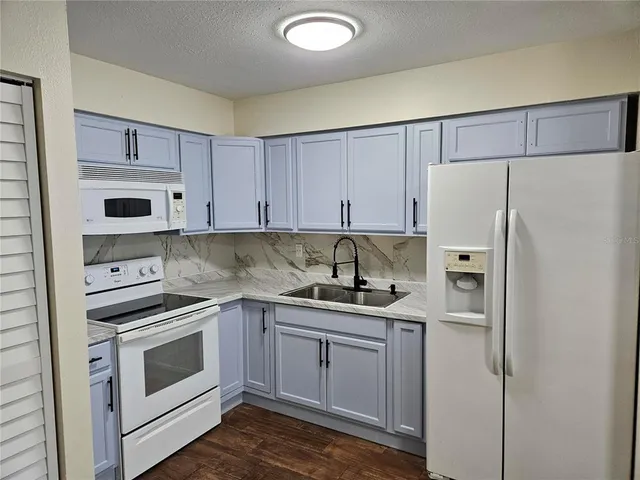 a bathroom with a toilet sink and shower