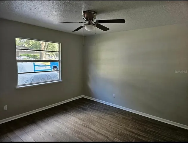 a view of a room with wooden floor