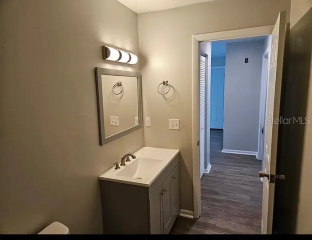 a view of a hallway with wooden floor
