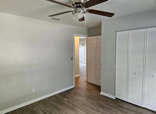 a view of an empty room with wooden floor